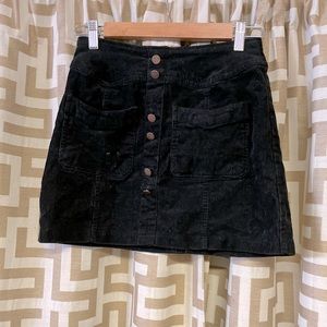 Black corduroy button up skirt.